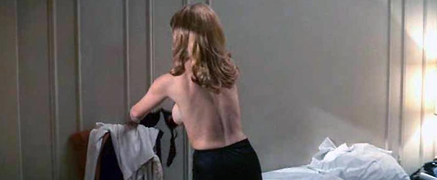 Ann-Margret is fully naked on her stomach on a bed, her ass and right breas...