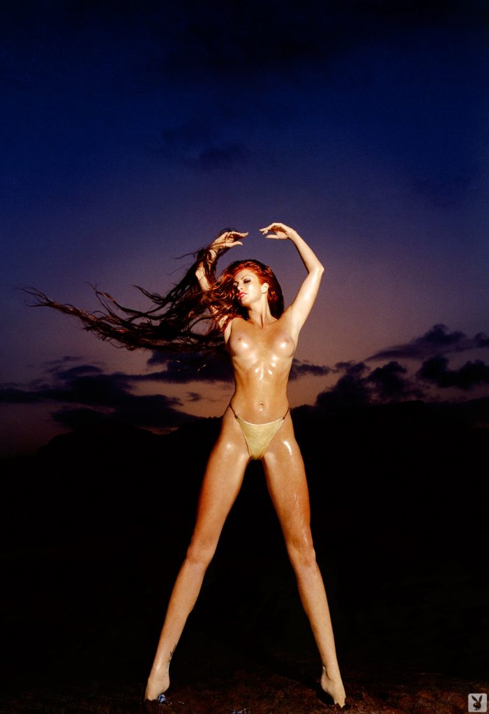 Redheaded Angie Everhart Showing Her Well-Oiled Ass and Toned Legs gallery, pic 2